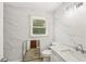 Bathroom featuring modern white marble-style tiling, vanity, and natural light at 10875 Shagbark Trl, Roswell, GA 30075