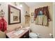 Charming bathroom with vanity, sink, and decorative window at 10875 Shagbark Trl, Roswell, GA 30075