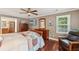 Inviting bedroom with hardwood floors, a window view, and comfortable seating at 10875 Shagbark Trl, Roswell, GA 30075
