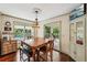 Bright dining area featuring windows, access to the porch, and an adjacent cabinet for storage at 10875 Shagbark Trl, Roswell, GA 30075