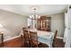 Dining room with hardwood floors, decorative chandelier, and wooden china cabinet at 10875 Shagbark Trl, Roswell, GA 30075