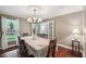 Bright dining room featuring hardwood floors, modern chandelier, and neutral walls at 10875 Shagbark Trl, Roswell, GA 30075