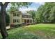 Inviting two-story home with a covered front porch, landscaped yard, and mature trees creating a serene setting at 10875 Shagbark Trl, Roswell, GA 30075