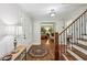 Welcoming foyer with hardwood floors, a staircase, and views into other rooms creating an inviting entrance at 10875 Shagbark Trl, Roswell, GA 30075