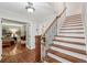 Grand foyer with hardwood floors, a staircase, and a glimpse into the bedroom at 10875 Shagbark Trl, Roswell, GA 30075