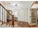 Elegant foyer with hardwood floors, staircase, and a decorative rug leading to various rooms in the home at 10875 Shagbark Trl, Roswell, GA 30075
