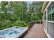 Enjoy wooded views from this backyard hot tub and wood deck at 10875 Shagbark Trl, Roswell, GA 30075