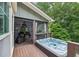 Relax in this backyard hot tub with screened-in porch and wood deck at 10875 Shagbark Trl, Roswell, GA 30075