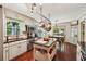 Open kitchen featuring stainless steel appliances, an island, and adjacent dining area for Gathering meals at 10875 Shagbark Trl, Roswell, GA 30075