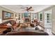 Inviting living room with brick fireplace, built-in bookshelves and comfortable leather furniture at 10875 Shagbark Trl, Roswell, GA 30075