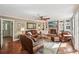 Cozy living room with brick fireplace, built-in bookshelves, and comfortable leather furniture at 10875 Shagbark Trl, Roswell, GA 30075