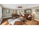 Inviting living room with hardwood floors, comfortable leather seating, and ample natural light at 10875 Shagbark Trl, Roswell, GA 30075