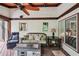 Cozy porch featuring wood floors, stone fireplace, overhead fan, and comfortable furniture at 10875 Shagbark Trl, Roswell, GA 30075