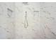 Shower featuring modern white marble-style tiling, shower head, and built-in shelving at 10875 Shagbark Trl, Roswell, GA 30075
