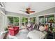 Bright sunroom featuring large windows, comfortable seating, and a relaxing atmosphere at 10875 Shagbark Trl, Roswell, GA 30075