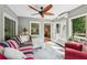 Bright sunroom with many windows, comfortable seating, and a view to the outside patio at 10875 Shagbark Trl, Roswell, GA 30075