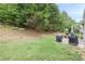 Manicured backyard with lush trees and lawn at 1245 Mountain Ivey Ct, Sugar Hill, GA 30518