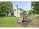 View of the backyard with playground and privacy fence at 1245 Mountain Ivey Ct, Sugar Hill, GA 30518