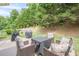 Backyard patio with outdoor furniture and plush pillows at 1245 Mountain Ivey Ct, Sugar Hill, GA 30518