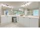 Bathroom featuring a long vanity with double sinks and modern fixtures at 1245 Mountain Ivey Ct, Sugar Hill, GA 30518