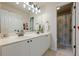 Bathroom with a dual vanity and framed mirror at 1245 Mountain Ivey Ct, Sugar Hill, GA 30518