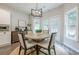 Cozy breakfast nook features a round table with seating for four and natural light from the double doors and windows at 1245 Mountain Ivey Ct, Sugar Hill, GA 30518