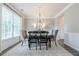 Dining room featuring a wood table, neutral colors, and a chandelier creating a space perfect for entertaining at 1245 Mountain Ivey Ct, Sugar Hill, GA 30518