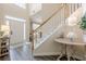 Entryway featuring wood floors, a staircase, and a decorative side table, creating an inviting and stylish space at 1245 Mountain Ivey Ct, Sugar Hill, GA 30518