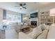 Cozy living room with a fireplace, built-in shelves, and large window with views at 1245 Mountain Ivey Ct, Sugar Hill, GA 30518