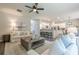 Spacious living room open to the kitchen, with wood floors and comfortable seating, ideal for modern living and entertaining at 1245 Mountain Ivey Ct, Sugar Hill, GA 30518