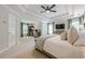 Spacious main bedroom with a tray ceiling, fan, carpet, and a sitting area with desk at 1245 Mountain Ivey Ct, Sugar Hill, GA 30518