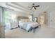 Spacious main bedroom features a trey ceiling, neutral tones, and ample natural light with a view into the main bath at 1245 Mountain Ivey Ct, Sugar Hill, GA 30518