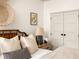 This bedroom features a cozy bed, wooden accents, and a view of the double closets, creating a comfortable retreat with lots of natural light at 1602 Windsor Walk, Avondale Estates, GA 30002