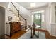 Foyer with hardwood floors, staircase, vintage furniture, and bright green front door at 1602 Windsor Walk, Avondale Estates, GA 30002