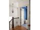 Bright hallway with stairs, hardwood floors, and a glimpse into the blue accent wall of a room at 1602 Windsor Walk, Avondale Estates, GA 30002