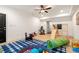 A spacious playroom with ceiling fan, carpet, bright light, and toys provides a fun area at 1602 Windsor Walk, Avondale Estates, GA 30002