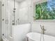 Bright bathroom with a glass-enclosed shower and a soaking tub at 2760 Fraser Se St, Smyrna, GA 30080