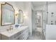 Stylish bathroom showcasing double sinks, a marble countertop, gold hardware, and a glass-enclosed shower at 2760 Fraser Se St, Smyrna, GA 30080