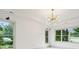 Bright room features a modern light fixture, white walls, and large windows offering views of the surrounding greenery at 2760 Fraser Se St, Smyrna, GA 30080
