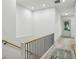 Hallway featuring a staircase with a wood railing, white walls, and a decorative rug at 2760 Fraser Se St, Smyrna, GA 30080
