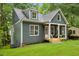 Charming craftsman home with a green exterior, inviting front porch, and lush lawn at 2760 Fraser Se St, Smyrna, GA 30080