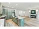 Open concept: kitchen with green cabinets, stainless steel appliances plus living room with fireplace at 2760 Fraser Se St, Smyrna, GA 30080