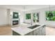 Bright kitchen boasts a marble island, stainless steel appliances and a cozy fireplace at 2760 Fraser Se St, Smyrna, GA 30080