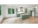 Kitchen with green cabinets, stainless steel appliances, marble countertop, plus view of the living area at 2760 Fraser Se St, Smyrna, GA 30080