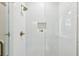 Clean shower featuring white subway tile, glass door, and bronze shower head with built in niche at 2760 Fraser Se St, Smyrna, GA 30080