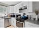 Modern kitchen with white cabinets, granite countertops, and a stainless steel range at 406 Country Park Se Dr, Smyrna, GA 30080