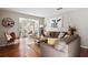 Inviting living room with neutral colors, hardwood floors, and access to the sunroom at 406 Country Park Se Dr, Smyrna, GA 30080
