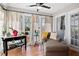 Bright sunroom with a ceiling fan, large windows, and a comfortable chaise lounge at 406 Country Park Se Dr, Smyrna, GA 30080