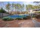 Community tennis court surrounded by mature trees and fencing at 406 Country Park Se Dr, Smyrna, GA 30080