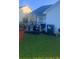 Fenced backyard featuring green grass, seating and eating area with an umbrella, and a grill at 10600 Pine Forest Ln, Jonesboro, GA 30238